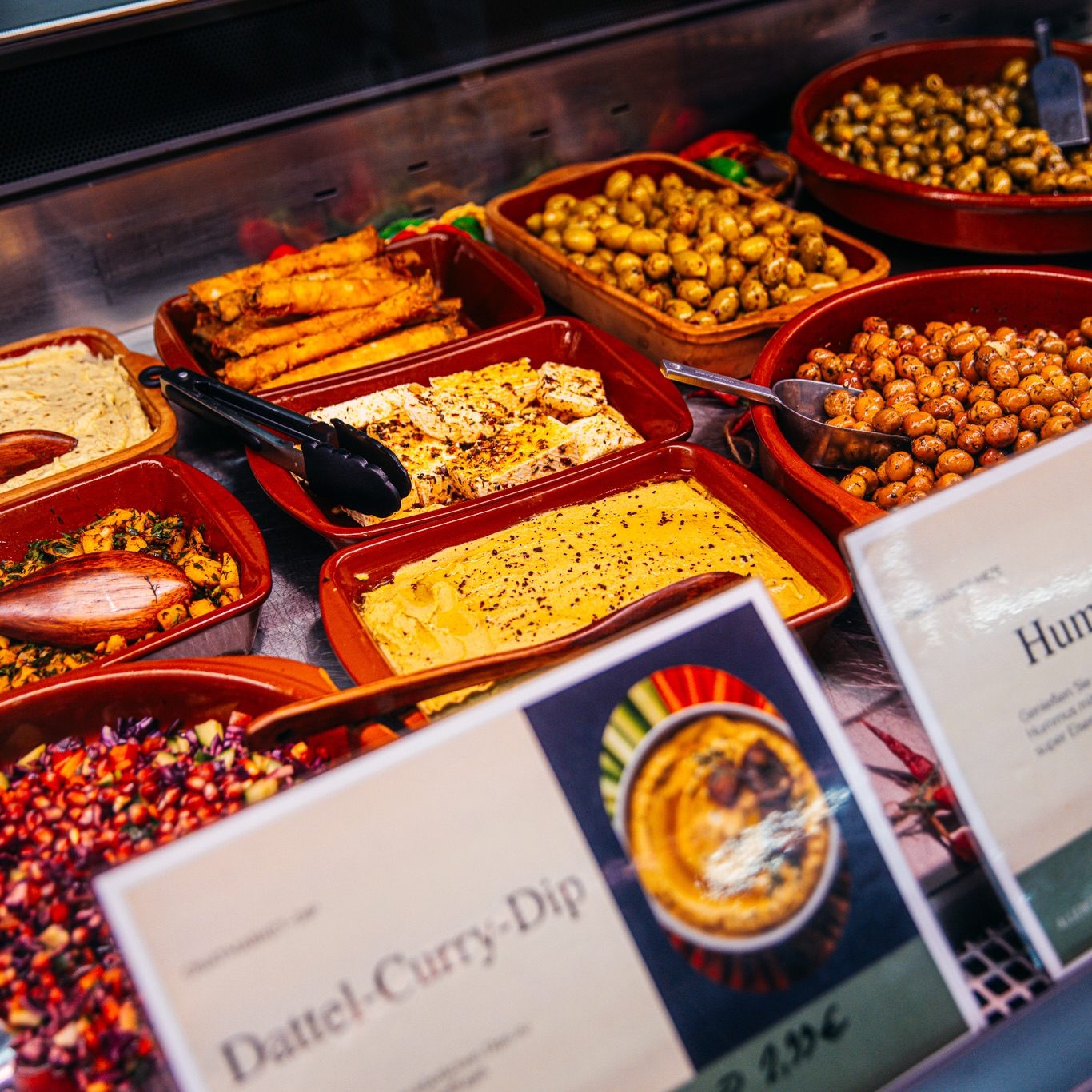 Detailansicht der Mezzebar mit Dips und Oliven